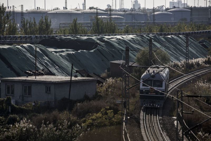 A train passes piles of coal at the Qinhuangdao Port in Qinhuangdao, China, on Friday, Oct. 28, 2016. China's efforts to quell surging coal prices showed signs they’re working, with benchmark prices dropping for the first time in a year as the country's production rose to the highest in seven months. A train passes piles of coal at the Qinhuangdao Port in Qinhuangdao, China, on Friday, Oct. 28, 2016. China's efforts to quell surging coal prices showed signs they’re working, with benchmark prices dropping for the first time in a year as the country's production rose to the highest in seven months.